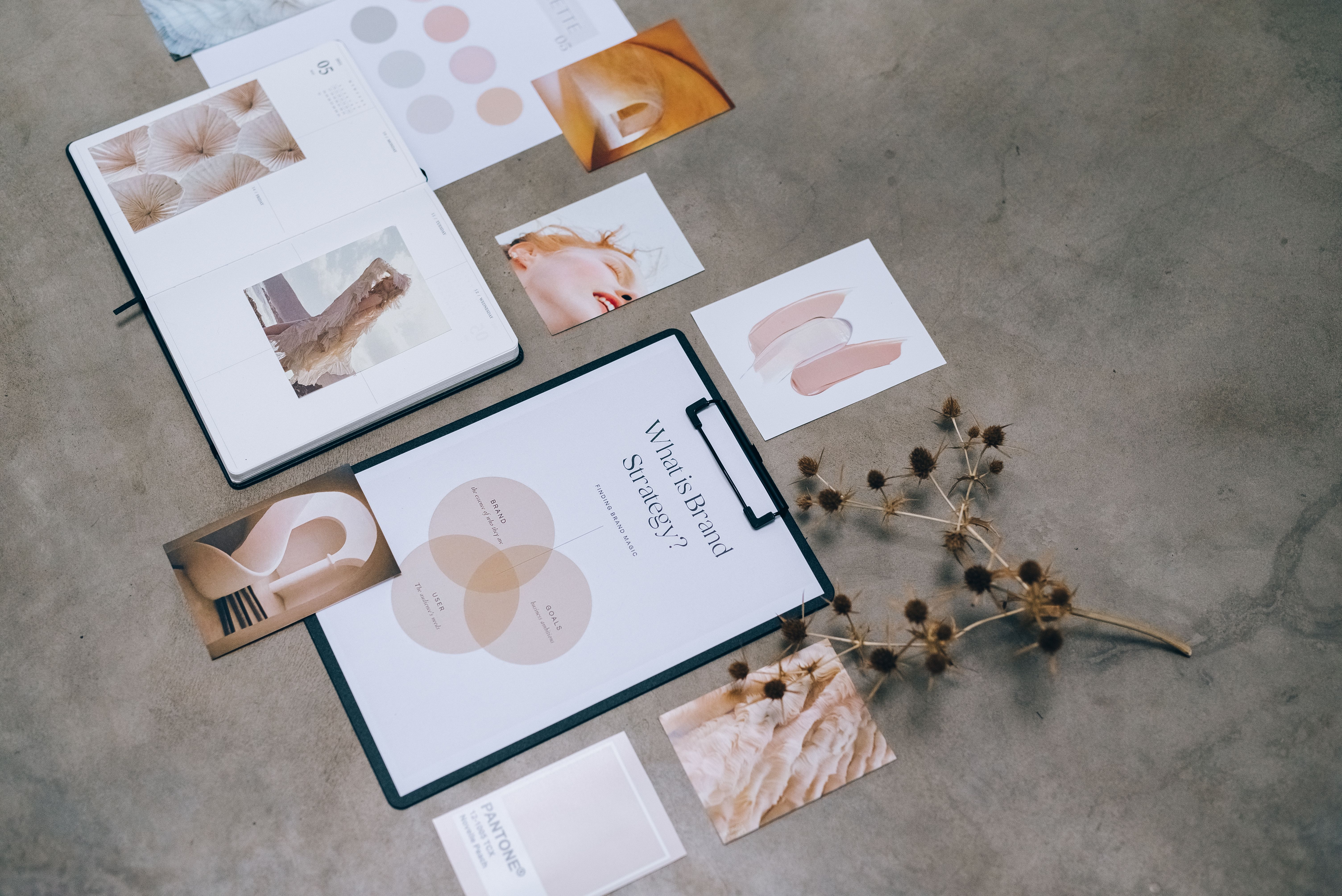 Brand strategy documents and design elements arranged on a creative desk